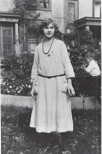 College age Dorothy on a school break in 1930 standing outside.