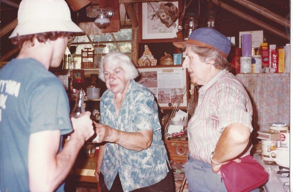 Dorothy Molter handing a root beer to a guest in the Isle of Pines.