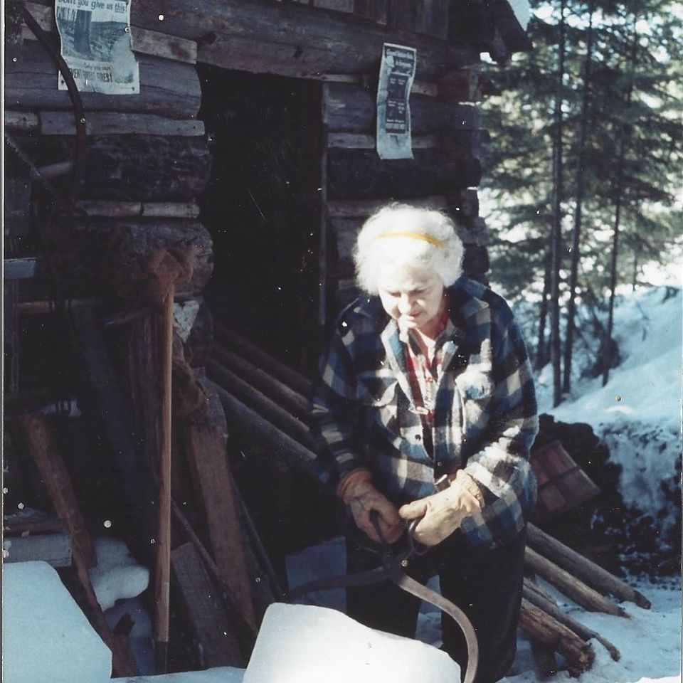 Dorothy Molter picking up a ice block during the winter