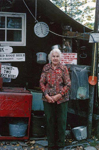 Dorothy Molter standing in front of the building that is now her museum. 
