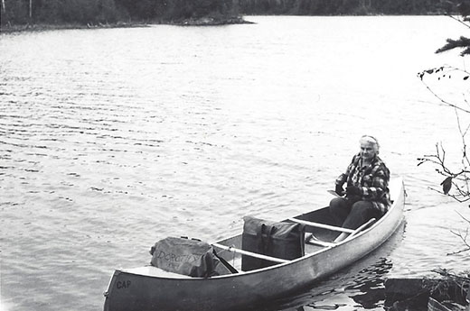 Dorothy outside in a canoe on Knife Lake in North Woods.