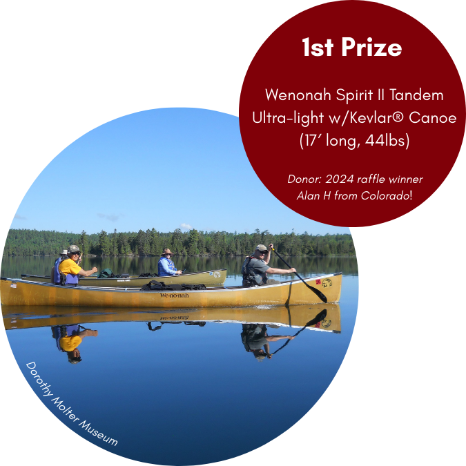 Image of four people in two canoes on a lake 